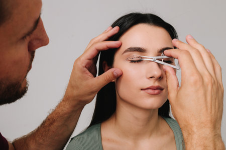 Plastic surgeon is measuring surgical distance within eye of his patient using Castroviejo caliper....