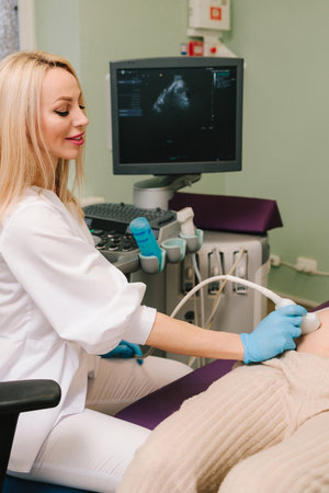 Pregnancy health checkup with ultrasound equipment. Pregnant woman on ultrasound examination at hospitalの写真素材