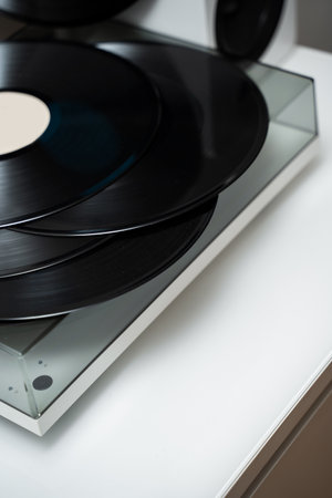 Closeup of modern turntable player and vinyl records. Vintage vinyl cartridges with Hi-Fi sound