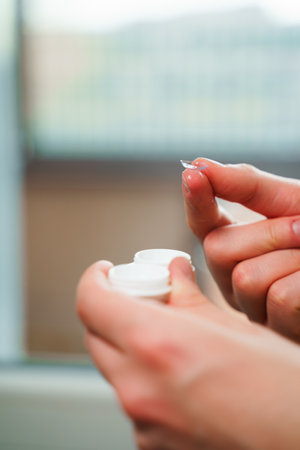 Closeup contact lens for vision correction in hands. Eyesight correction with optical lensの写真素材