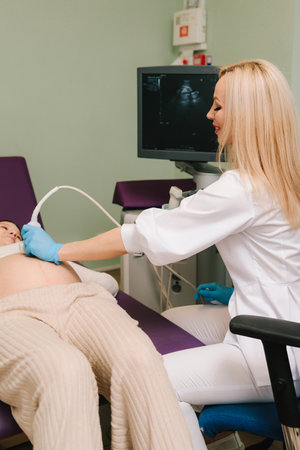 Pregnancy health checkup with ultrasound equipment. Pregnant woman on ultrasound examination at hospitalの写真素材