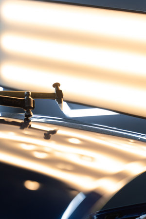 Controlled taps with a knockdown tool reshape metal warped by hail. PDR technician uses a knockdown tool and hammer combo to correct hail dents. Focused strikes realign metal without harming paintの写真素材