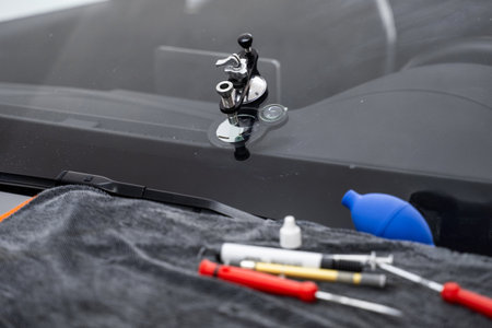 Bridge tool for injecting resin in damaged windshield. Accurate application improves durability and appearance. Mounted windshield repair bridge holds resin applicators securely over the crackの写真素材