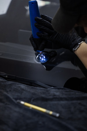 Windshield Crack Repair with Drill. Drilling a crack in the windshield prepares the impact area for...