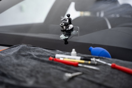 Mounted windshield repair bridge holds resin applicators securely over the crack. Bridge tool for injecting resin in damaged windshield. Accurate application improves durability and appearanceの写真素材