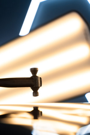 Hammer tool to correct dents without damaging car paint in PDR work. PDR hammer tool for paintless dent repair positioned above a car panelの写真素材