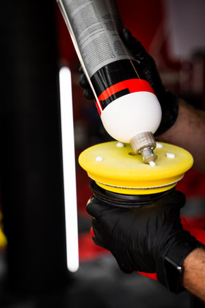 Applying compound to yellow polishing pad. Car detailing and paint correction preparation. Polishing...