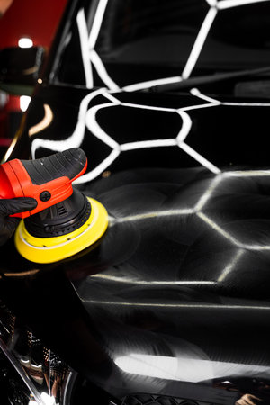 Car detailing polishing restores surface clarity and maximizes gloss. Machine buffing removes imperfections and boosts shine. Automotive polishing improves car surface reflection. Car Paint Polishingの写真素材