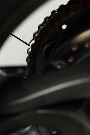 Oiling motorcycle chain helps reduce wear, prevent rust, and ensure clean drivetrain for top riding performance. Motorcycle Chain Lubrication with Oil. Clean oil spray is applied to motorcycle chainの写真素材