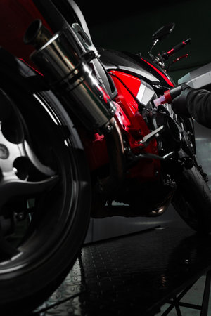 Precision oil fill operation on a red sportbike to ensure proper engine lubrication. Motorcycle Oil Refill. Replacing engine oil in a sports motorcycle to ensure top performance and engine longevityの写真素材