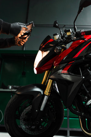 Mechanic performing system diagnostics via tablet. Motorcycle system diagnostic, scanning for faults...
