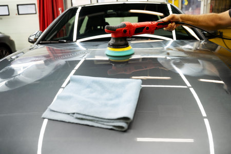 Polishing protects the paint by removing light scratches and restoring color depth. Polishing removes swirl marks and oxidation, restoring deep gloss and paint clarityの写真素材