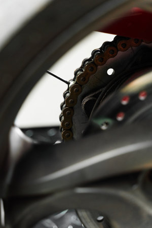Oiling motorcycle chain helps reduce wear, prevent rust, and ensure clean drivetrain for top riding performance. Motorcycle Chain Lubrication with Oil. Clean oil spray is applied to motorcycle chainの写真素材
