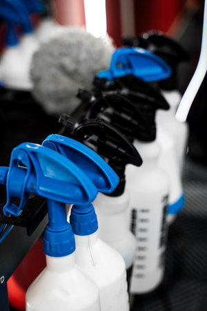 Detailing Spray Bottles with Car Care Products. Row of spray bottles filled with automotive detailing liquids stands ready for use. Sprayer nozzles with multiple detailing chemicalsの写真素材