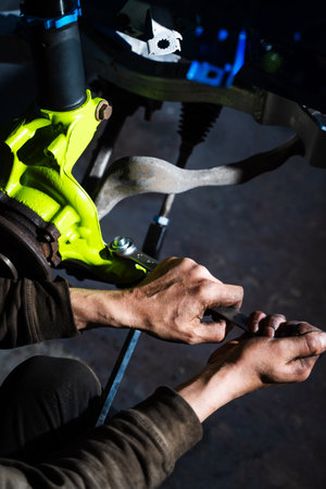 Disc brake and coilover strut setup being fine-tuned for drift racing. Front Suspension and Brake Disc Installation. Performance brake disc and strut assembly installed for drift stopping powerの写真素材