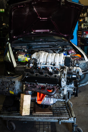 Engine swap in action featuring intake and transmission. Engine Swap in Progress. Custom V8 engine...
