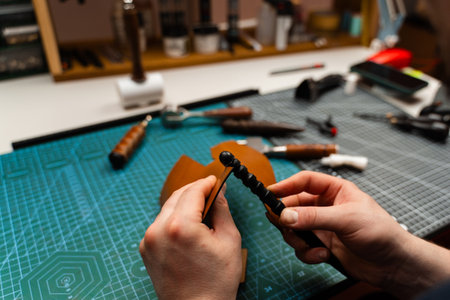 Leather burnishing creates polished edges that resist wear. Using a burnisher, artisans refine leather edges for durability and shine. Leather edge burnishing provides smooth, glossy finishingの写真素材