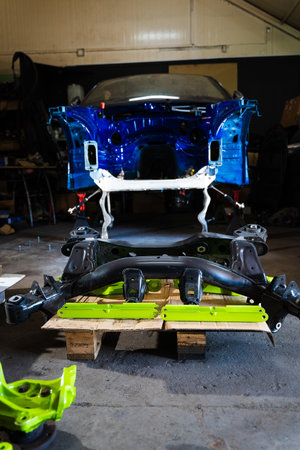 Performance suspension components are organized for a build with freshly painted calipers, knuckles, and hubsの写真素材