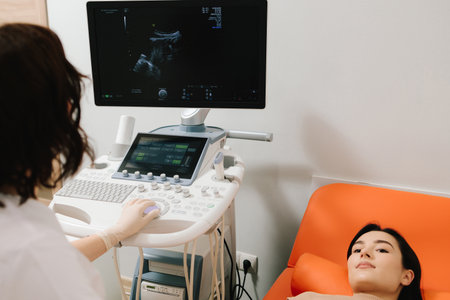 Gynecologist uses ultrasound equipment for reproductive health evaluation. Gynecologist performs an...