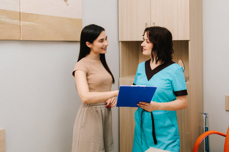Gynecologist Consultation with Medical Records. Consultation between a gynecologist and patient involves reviewing health data to ensure preventive reproductive careの写真素材