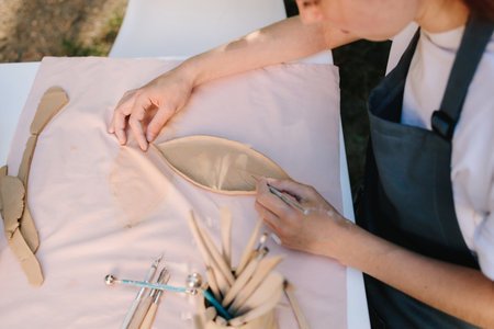 Clay Sculpting Work close-up. Clay carving shows precision and detail in ceramic crafting. Pottery...