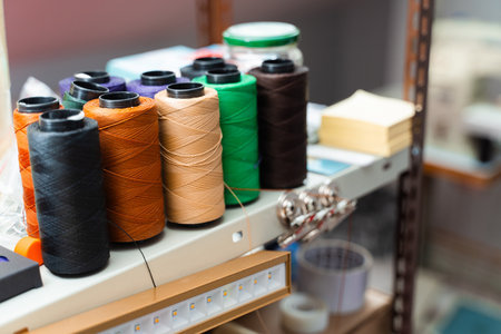 Colorful spools of durable thread. Multiple spools of strong sewing thread in vibrant colors for...