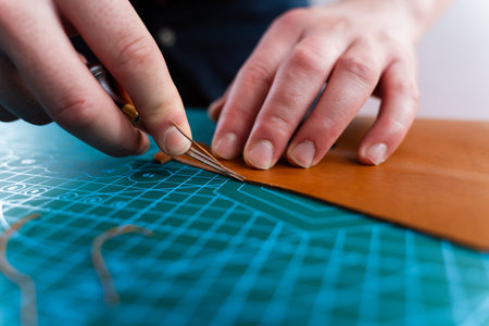 Craftsman refines leather edges with trimming tool, ensuring smooth curves and clean lines. Trimming...