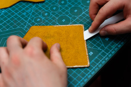 Pressing glued leather with a roller ensures tight bonding and smooth edges. Leather roller is used...
