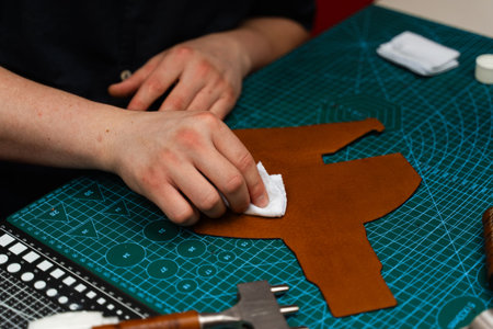 Applying conditioner or dye to leather with a cloth. Conditioning leather with a cloth restores...
