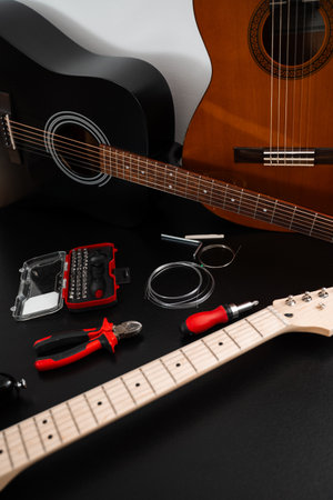 Guitar Maintenance and Accessories. Acoustic and electric guitars with strings, pliers, and repair...