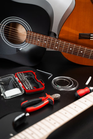 Guitar Maintenance and Accessories. Acoustic and electric guitars with strings, pliers, and repair...