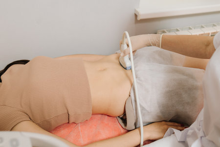 Abdominal ultrasound. Gynecologist uses ultrasound equipment for reproductive health evaluation....