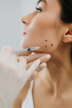 Bruxism injecting for teeth grinding by a cosmetologist. Bruxism injection facial for a treatment...