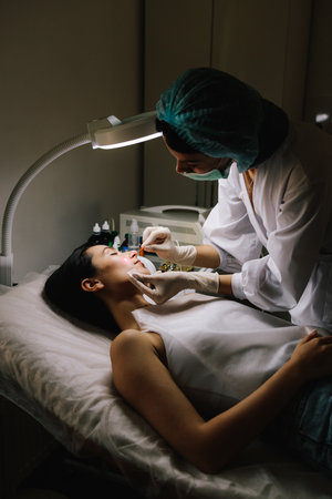 Aesthetic laser removal of nevi and benign growths. Dermatologist performs precise laser removal of...