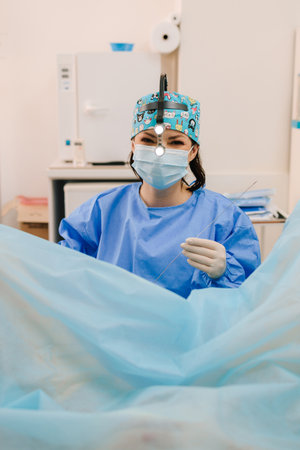 Minimally invasive gynecological procedure using sterile instruments. Ongoing gynecological procedure in a sterile gynecology clinic. Gynecologist performs intrauterine interventionの写真素材