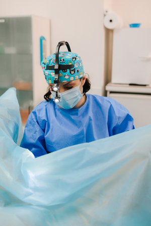Gynecologist inserts an intrauterine device IUD for long-term contraception. Gynecologist performing IUD insertion. Intrauterine device placement as a safe and effective contraceptive optionの写真素材
