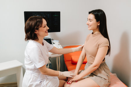 Gynecologist reassuring woman after gynecological exam. Post-exam consultation with gynecologist. Gynecologist consulting patient before ultrasound examinationの写真素材