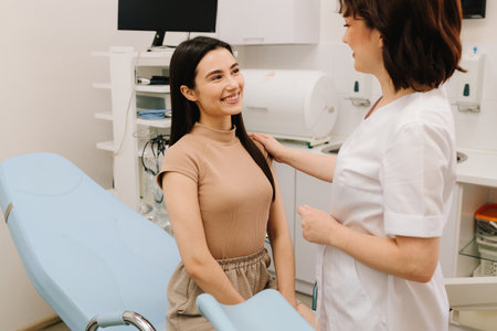 Gynecologist consulting patient before ultrasound examination. Gynecologist reassuring woman after gynecological exam. Post-exam consultation with gynecologistの写真素材