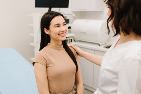 Gynecologist consulting patient before ultrasound examination. Gynecologist reassuring woman after gynecological exam. Post-exam consultation with gynecologistの写真素材
