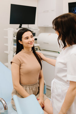 Gynecologist consulting patient before ultrasound examination. Gynecologist reassuring woman after gynecological exam. Post-exam consultation with gynecologistの写真素材