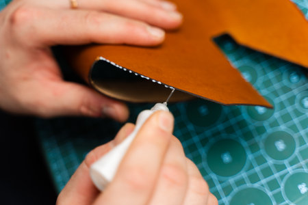 Gluing leather edges for stitching and lasting products. Leather glue application secures edges...