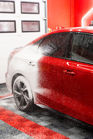 Foam application stage in auto detailing protects the paint while thoroughly cleaning the car body. Foam stage in car detailing protects the paint while loosening dirt, road grime, and contaminantsの写真素材