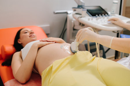 Pregnant woman on ultrasound examination at hospital. Pregnancy health checkup with ultrasound...