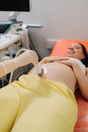 Pregnant woman on ultrasound examination at hospital. Pregnancy health checkup with ultrasound...