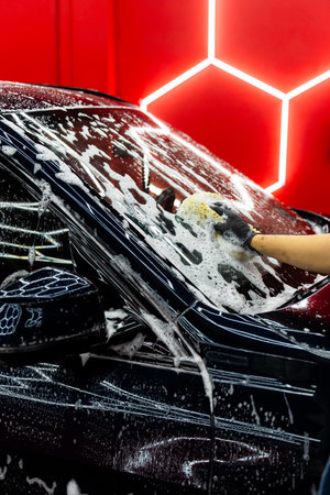 Sponge wash detailing removes dirt and grime from the car body while keeping paint surfaces safe. Car detailing sponge wash ensures gentle cleaning and thorough removal of contaminantsの写真素材