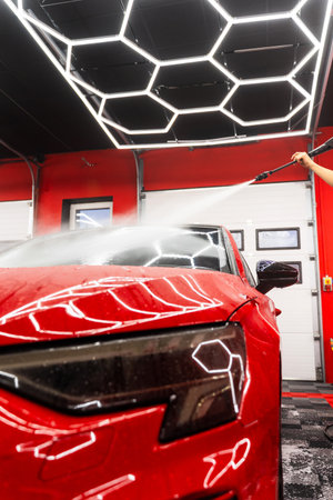 Milky pre-wash foam in auto detailing loosens contaminants from paint. Snow foam car wash coats the vehicle in a milk-like layer, safely lifting dirt and road grime before detailingの写真素材