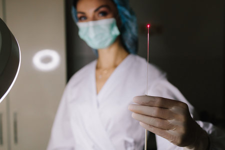 Laser Therapy. Precision laser therapy targets damaged skin cells to stimulate collagen regeneration and renewal. Doctor with laser for microneedling RF therapy in medical clinicの写真素材