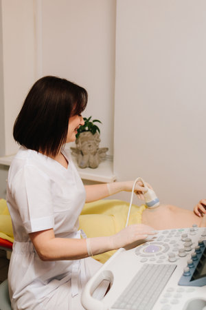 Pregnant woman on ultrasound examination at hospital. Pregnancy health checkup with ultrasound...