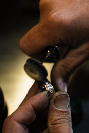 Jewelry artisan smoothing and polishing ring for glossy finishの写真素材