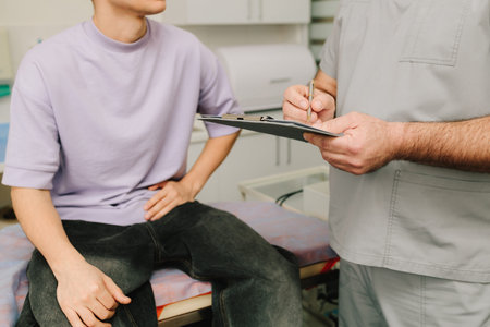 Urologist consulting patient on urinary issues and health history